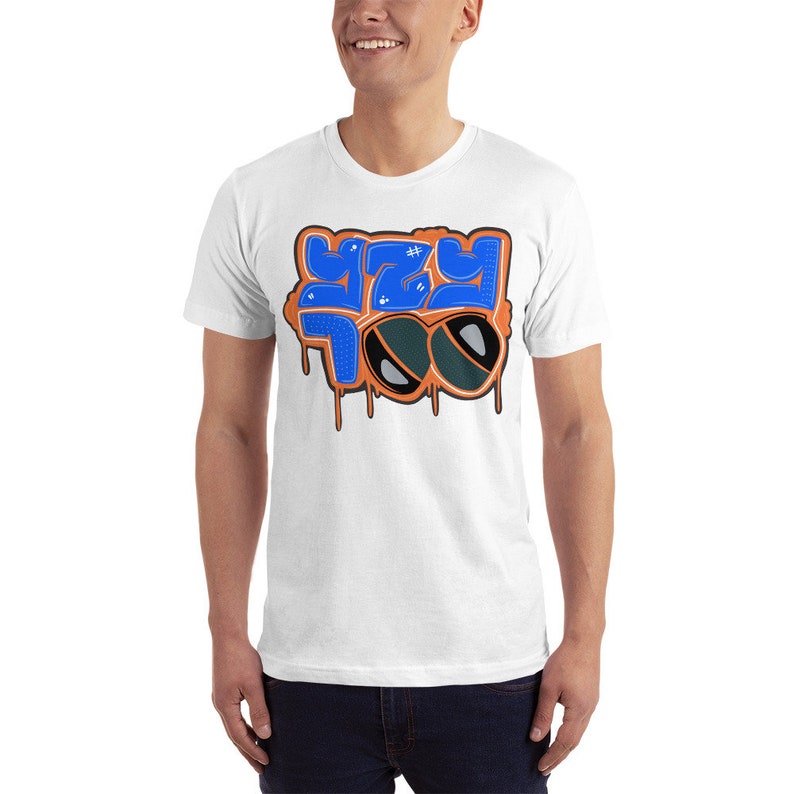 May include: White t-shirt with a blue and orange graphic design that says "Y2Y" with sunglasses.