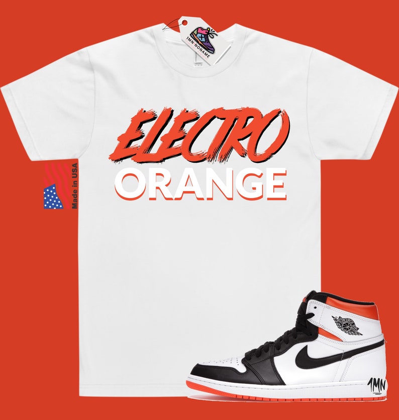May include: White t-shirt with the text "Electro Orange" in red and white. A pair of black and white high-top trainers with orange accents.