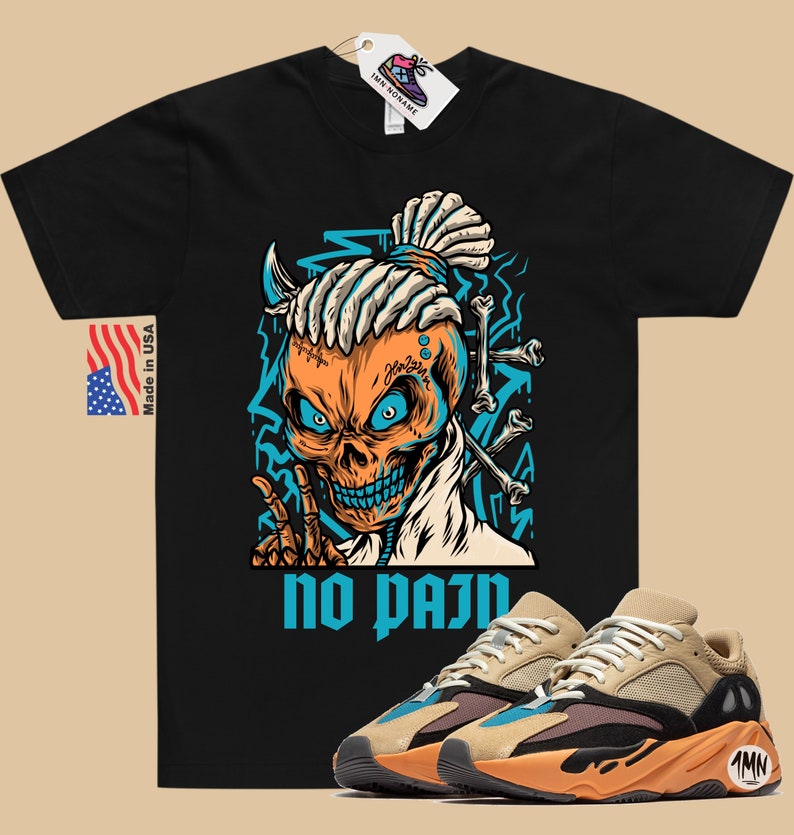 May include: Black t-shirt with a cartoon skull graphic and the text "no pain".  The skull has blue eyes, a blue and orange bandana, and a dreadlock hairstyle.  A pair of tan, orange, and blue sneakers are shown below the t-shirt.