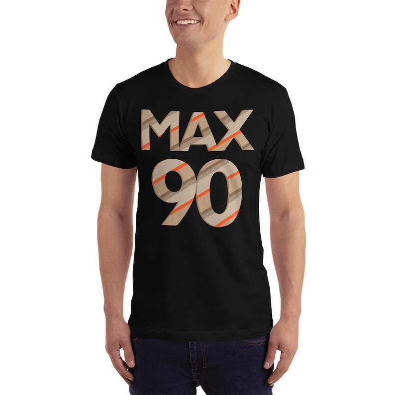 May include: Black t-shirt with the text "MAX 90" in brown and orange striped letters.