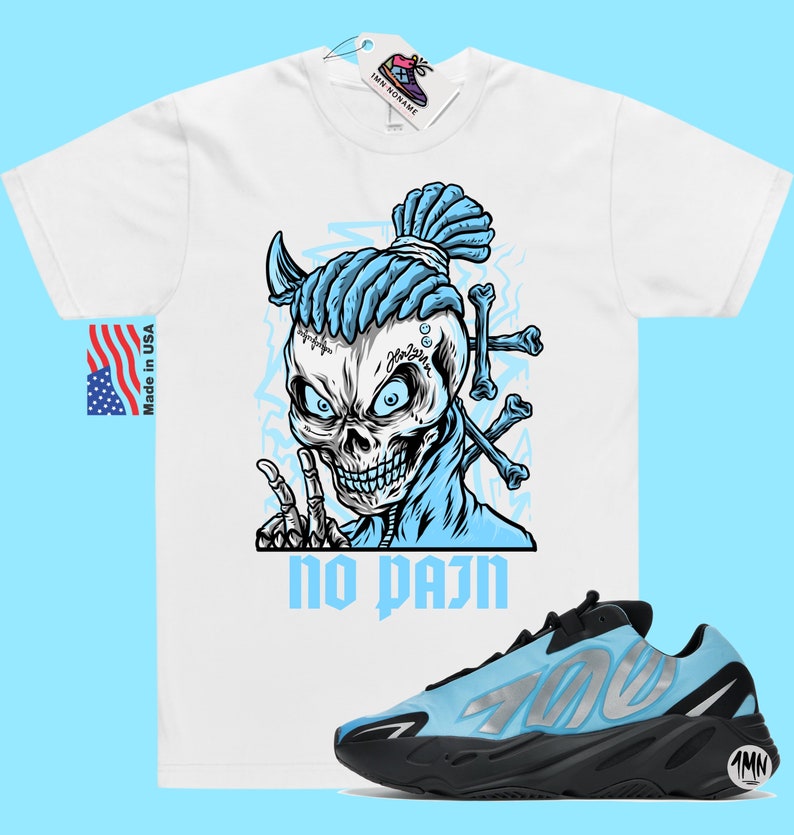 May include: White t-shirt with a blue skull graphic and the text "no pain".  A pair of blue and black sneakers with the number "700" on the side.