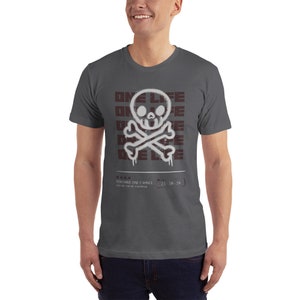 May include: A dark gray t-shirt with a white skull and crossbones graphic. The graphic is surrounded by the words "ONE LIFE" in a maroon color. The text "YOU HAVE ONE CHANCE" and "23:59:59" are printed below the graphic.
