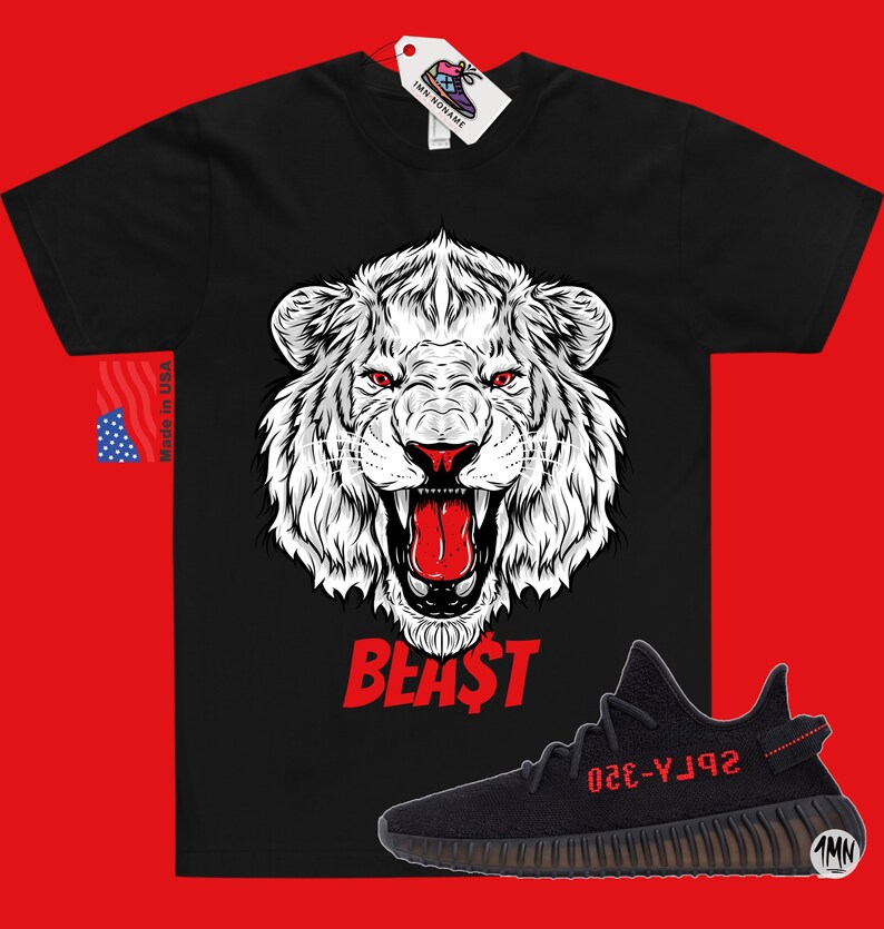 May include: Black t-shirt with a white lion graphic and the word "BEAST" in red. A black and red Yeezy sneaker with the text "YZY-350" in red is shown below the shirt.
