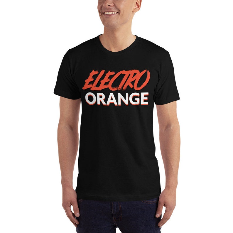 May include: Black t-shirt with a red and white graphic that says "Electro Orange".