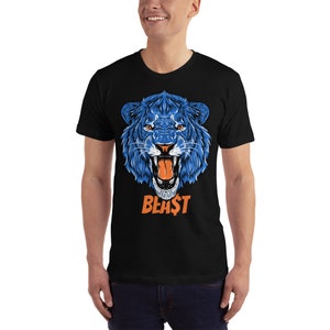 May include: A black t-shirt with a blue lion's head graphic and the word "BEAST" in orange letters.