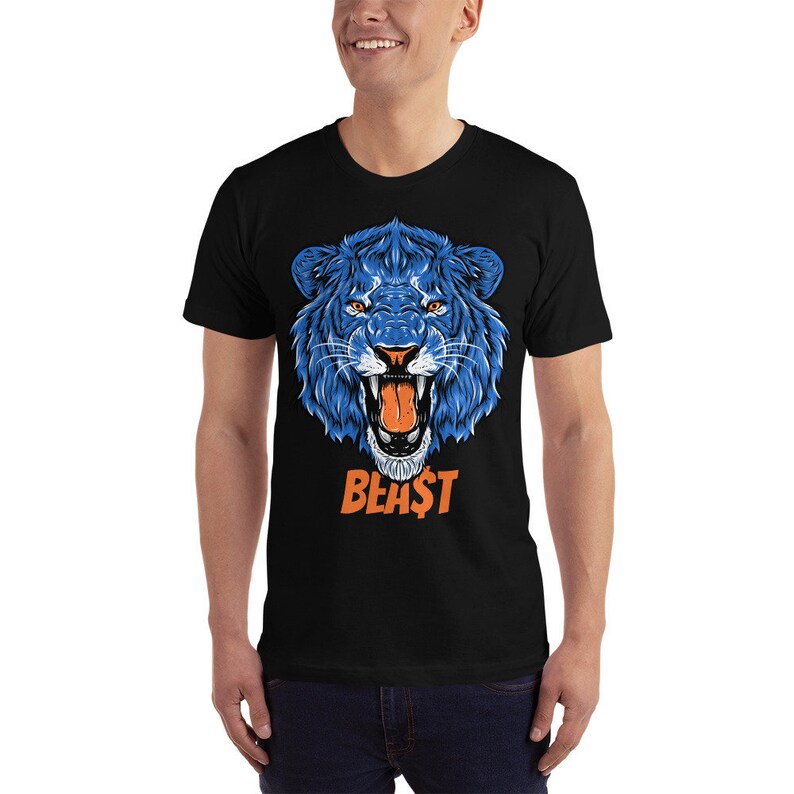 May include: A black t-shirt with a blue lion's head graphic and the word "BEAST" in orange letters.