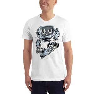 May include: White t-shirt with a graphic of a cartoon television character skateboarding. The character has a blue and gray color scheme and is wearing a white glove. The character is holding a video game controller in one hand and is making a 'peace' sign with the other hand. The character's eyes are wide open and have a 'kawaii' expression.