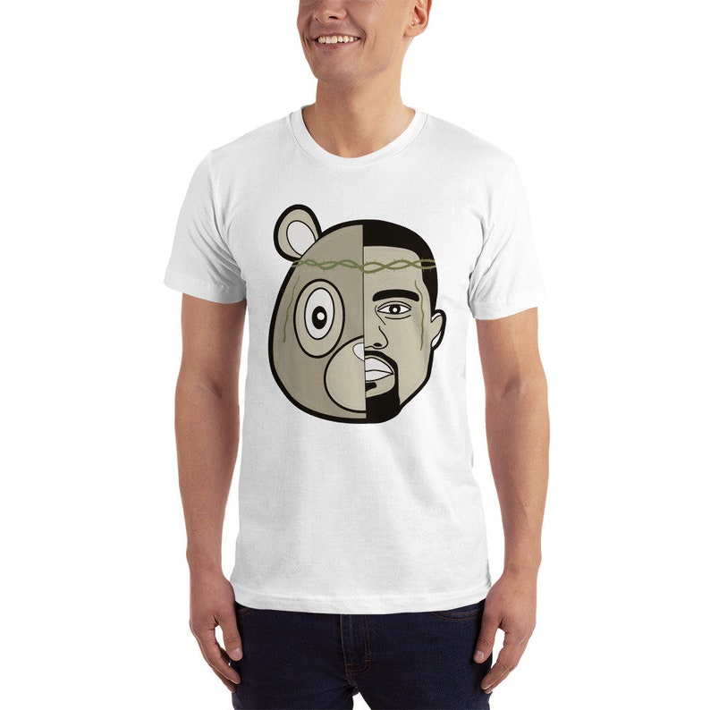 May include: White t-shirt with a graphic of a bear head and a man's face, split down the middle. The bear has a green leafy crown.