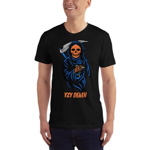 May include: Black t-shirt with a graphic of a grim reaper with an orange skull, blue cloak, and scythe. The reaper holds a blue rose. The text "YZY DEATH" is printed in orange below the graphic.