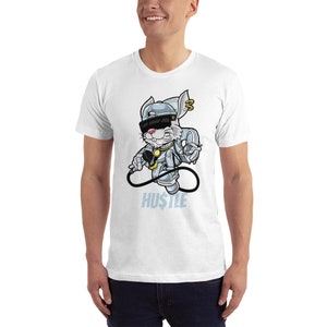 May include: White t-shirt featuring a cartoon rabbit wearing a backwards cap, sunglasses, and a gold chain. The rabbit is holding a microphone and the text "HU$TLE" is printed below the rabbit.