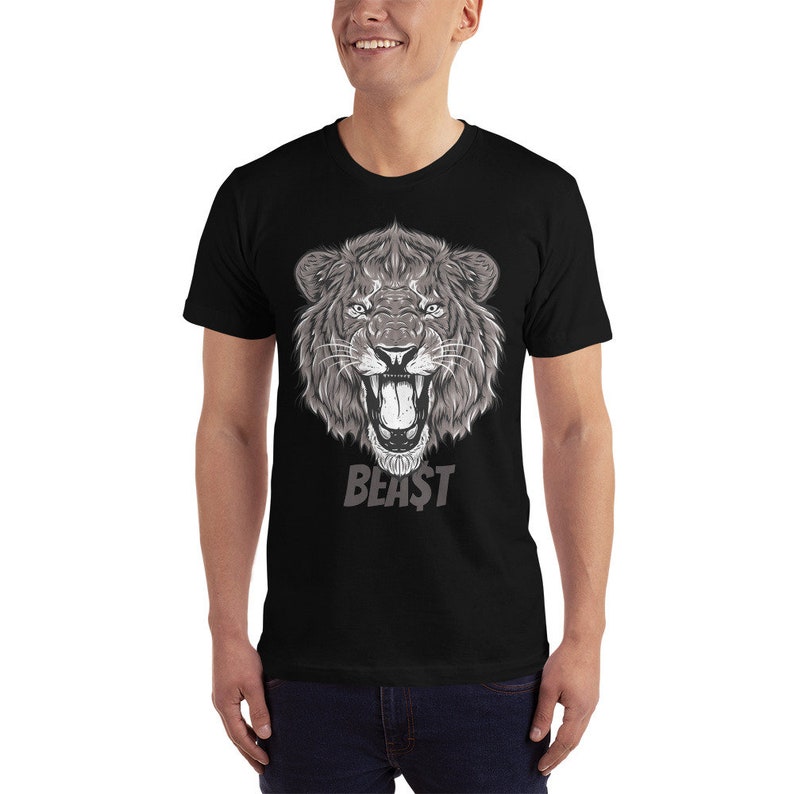 May include: Black t-shirt with a graphic of a roaring lion's head in gray and white. The text "BEAST" is printed below the lion's head.