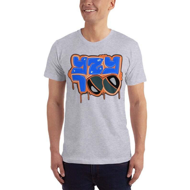 May include: A gray t-shirt with a blue and orange graphic design that says "YZY TOO" with sunglasses on top of the text.