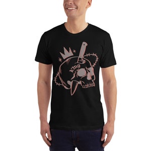 May include: Black t-shirt with a graphic of a skull with a knife through it. The skull has a crown on top and the word "King" tattooed on it.