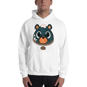 May include: White hooded sweatshirt featuring a cartoon bear face with teal fur, orange cross-stitched mouth, and gold chain necklace. The bear has round glasses and a dollar sign on one ear. The word "NZY" is on a pendant.