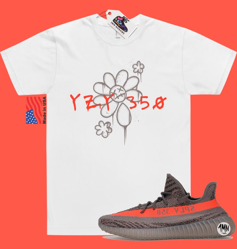 May include: White t-shirt with a gray flower graphic and the text "YZY 350" in red. A pair of gray and orange Yeezy 350 sneakers are shown below the t-shirt.