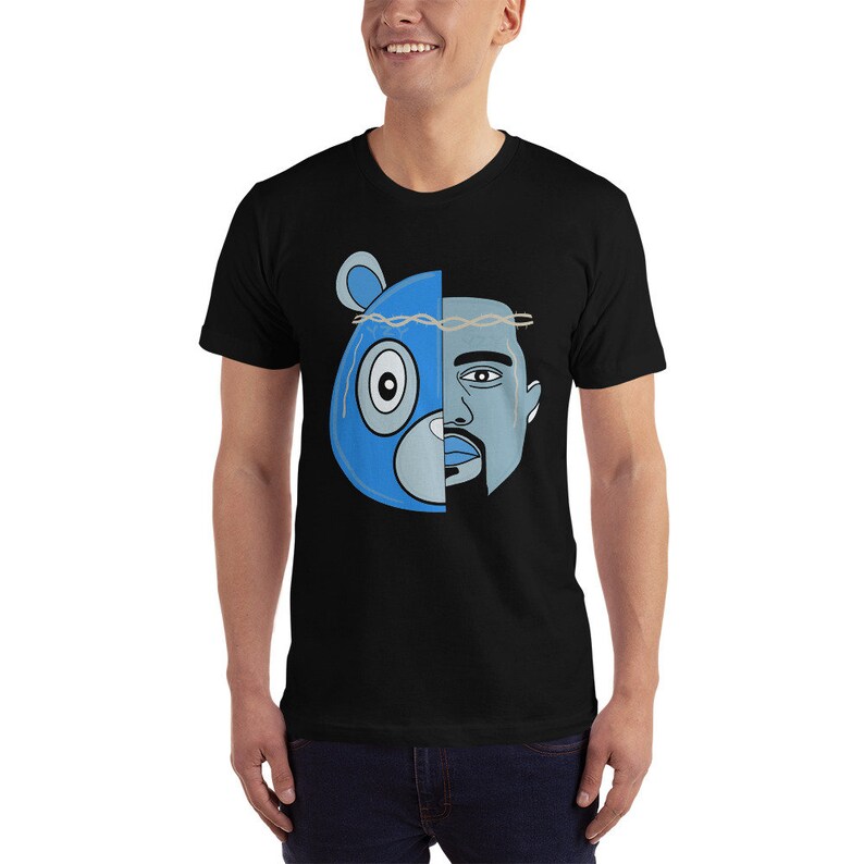 May include: Black t-shirt with a graphic of a blue bear head and a man's face, split down the middle. The bear has a crown of thorns on its head.