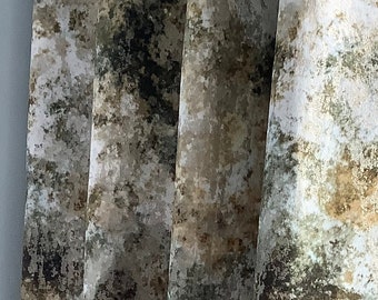 May include: Close-up of a set of curtains with a brown, green, and white abstract pattern. The curtains are made of a soft, textured fabric.