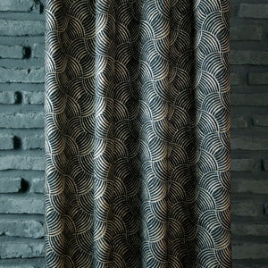 May include: Black fabric with a gold geometric pattern of overlapping semi-circles. The fabric has a textured, woven look.
