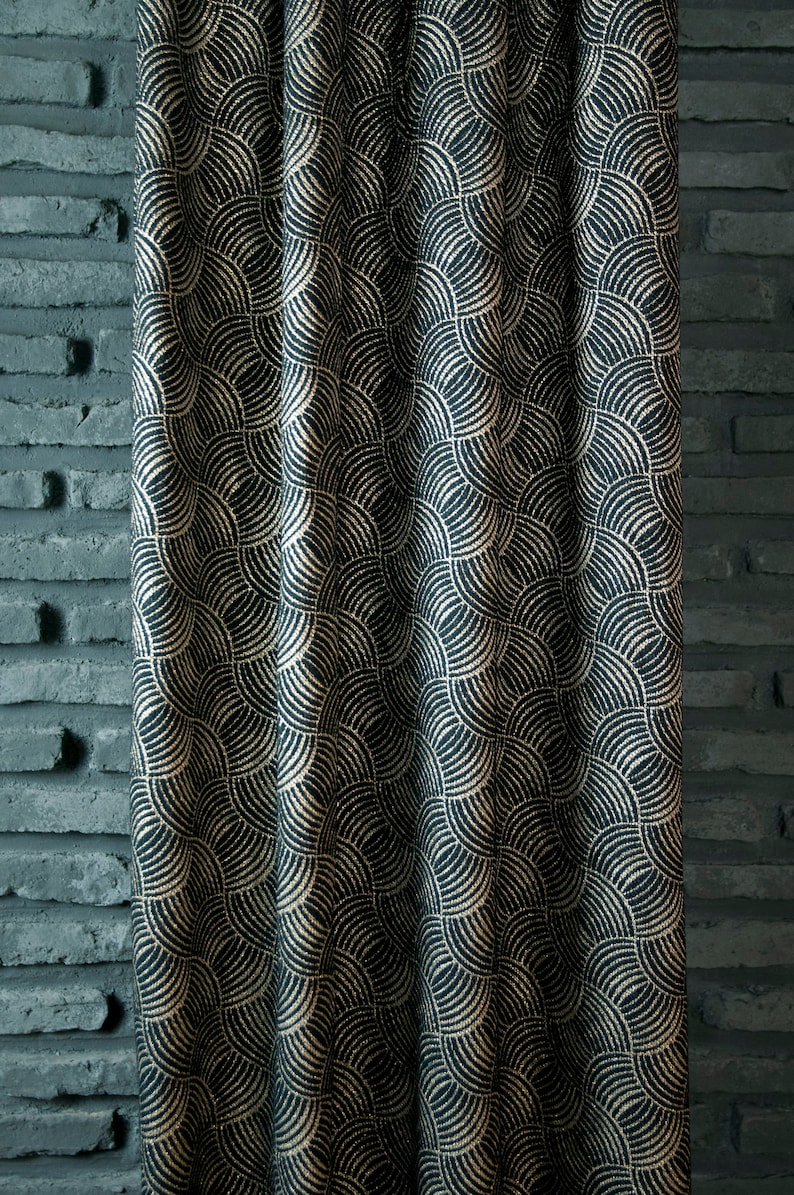 May include: Black fabric with a gold geometric pattern of overlapping semi-circles. The fabric has a textured, woven look.
