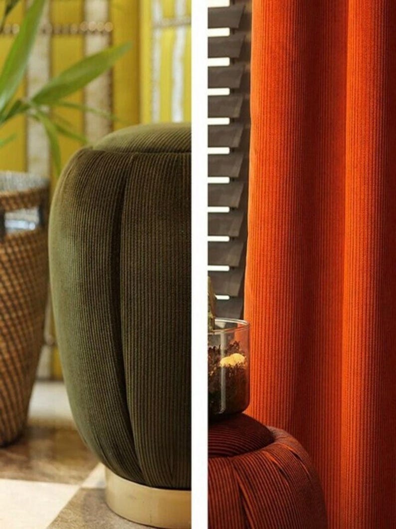 Olive ribbed velvet upholstery fabric on a rounded chair arm, paired with rust curtains in room