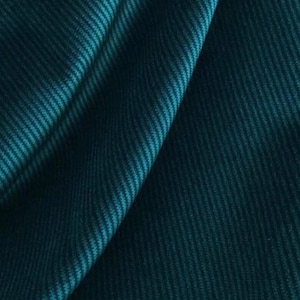Teal draped ribbed velvet upholstery fabric, close-up folds showing deep plush ribs and sheen