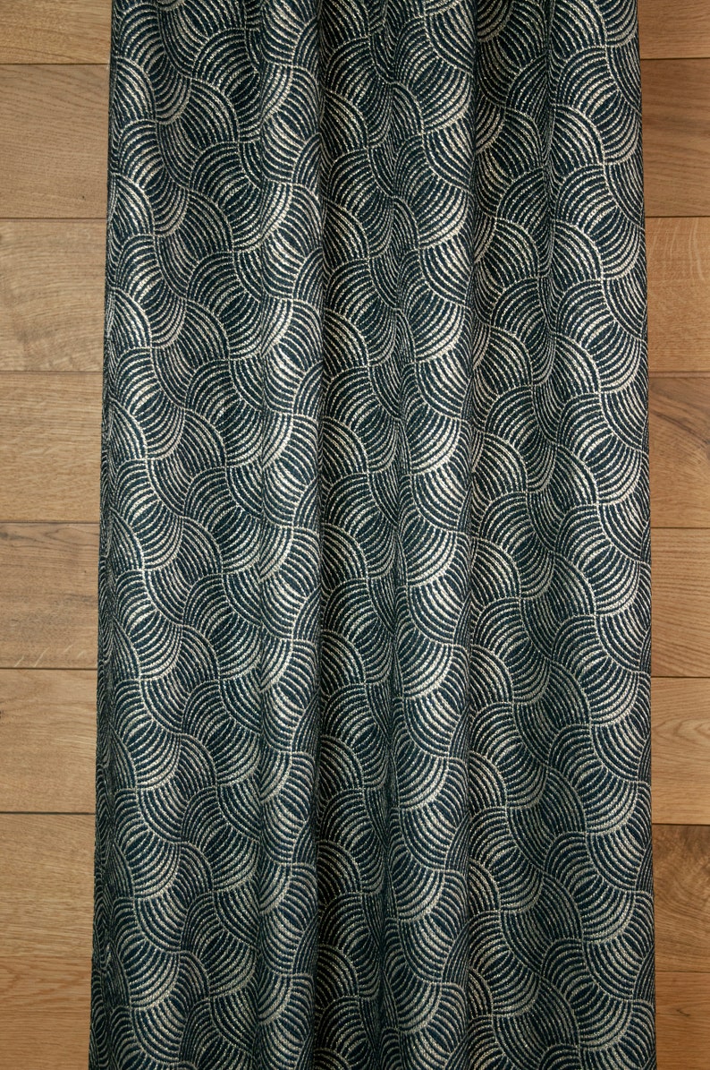 May include: A dark blue fabric with a white geometric pattern of overlapping semi-circles. The fabric has a textured, woven look.