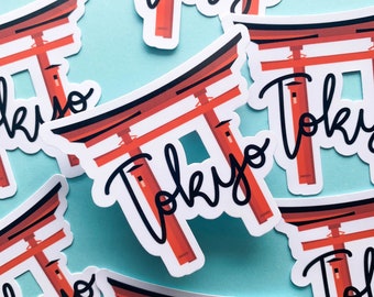 May include: A set of five stickers featuring a red Japanese torii gate with the word "Tokyo" written in black cursive script. The stickers are on a light blue background.