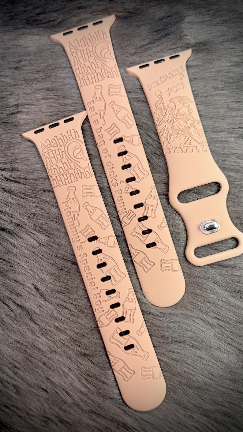 May include: Three light peach silicone watch bands featuring laser-engraved designs. The patterns include soda bottle outlines, ear illustrations, and text reading "Aaahhh", "Eat a bag of dicks Pony", "Mommy's Special Boy", "PREPARE FOR BYATTLE!"