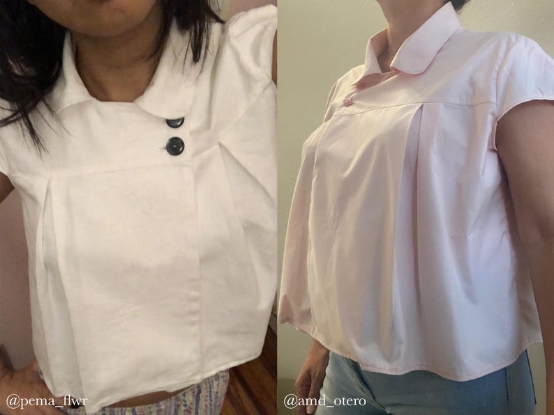 May include: Two short-sleeved blouses in the image. One is white with black buttons, and the other is light pink with a single button. Both have a collared neckline and pleated front details. The blouses are made of a smooth fabric.
