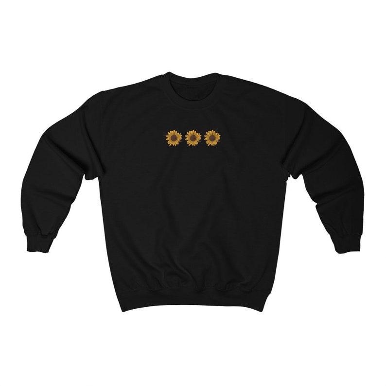 May include: Black sweatshirt with a row of three embroidered sunflowers in yellow and brown.