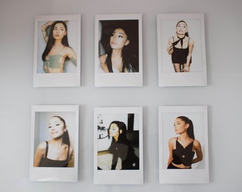May include: Six black and white Polaroid style photos of a woman with long dark hair. The photos are arranged in two rows of three on a white wall.