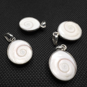 May include: Four silver pendants with white seashells. Each pendant features a spiral pattern in the center of the shell.
