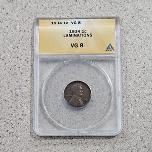 1934 1C Lincoln Wheat Penny 1 Cent Mint Error Bronze Coin Laminations ANACS Slabbed & Graded At VG 8