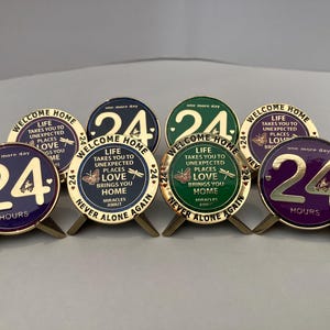 May include: Six gold-colored medallions with a purple, green, and blue background. Each medallion features a dragonfly, butterfly, and the text "Welcome Home", "Life Takes You To Unexpected Places", "Love Brings You Home", "One More Day", and "24 Hours".