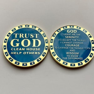 May include: Two gold-rimmed, blue circular tokens with inspirational messages. The front side reads "Trust God Clean House Help Others". The back side reads "God Grant me the Serenity to accept the things I cannot change. Courage to change the things I can. And Wisdom to know the difference."
