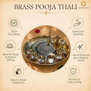 May include: A golden brass puja thali with a lit candle, small bowls of spices and nuts, a bell, and red roses. The thali is round and has an engraved design.