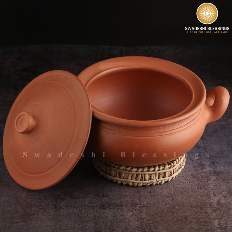 clay pot 
clay pot for cooking
clay cookware
swadeshi blessings
clay cooking pot
indian cookware
traditional cooking
clay pots
clay cookingpots with lid
pot
handi
claypots for cooking with spoon
indian kadai
claypan
clay biryani pot
Frying pan