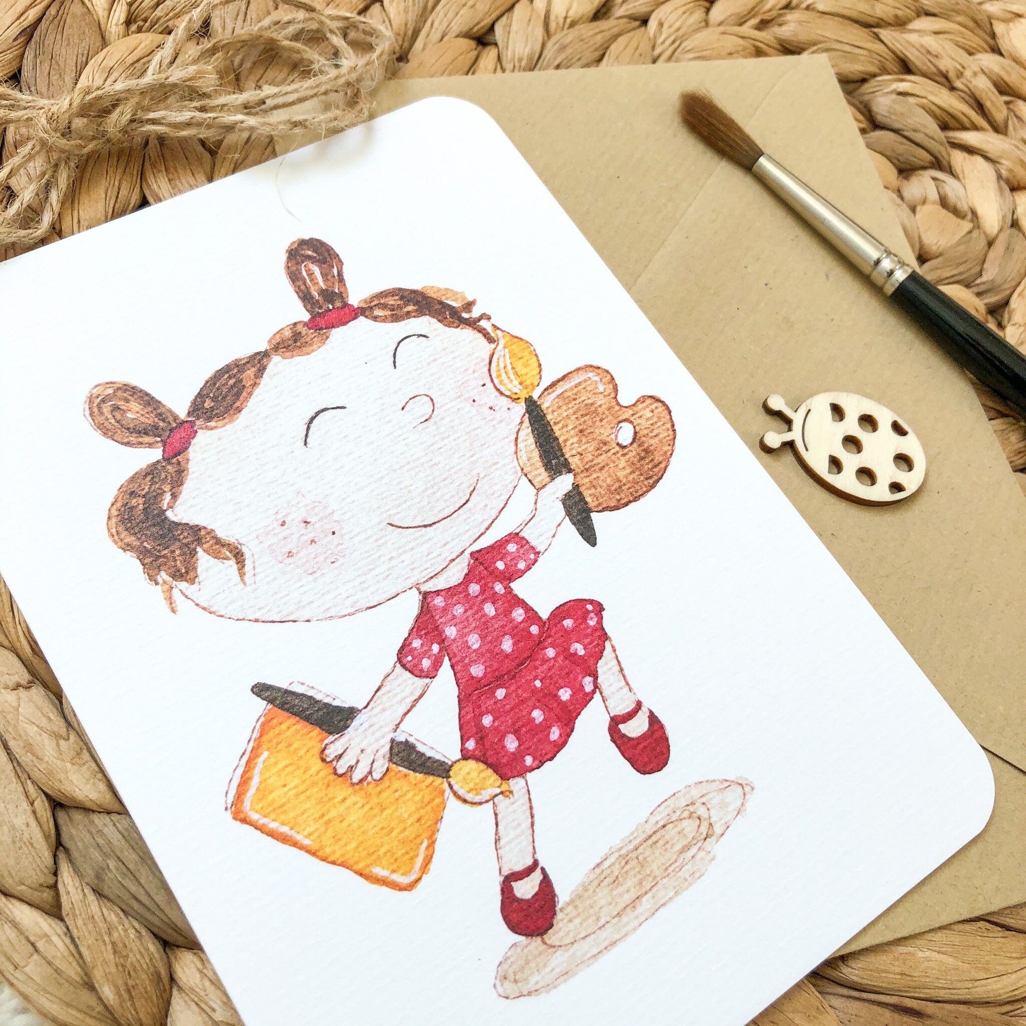 Hand-drawn postcard with a joyful girl jumping with a paint brush and colour pencils Hand-drawn postcard with a joyful girl jumping with a paint brush and colour pencils