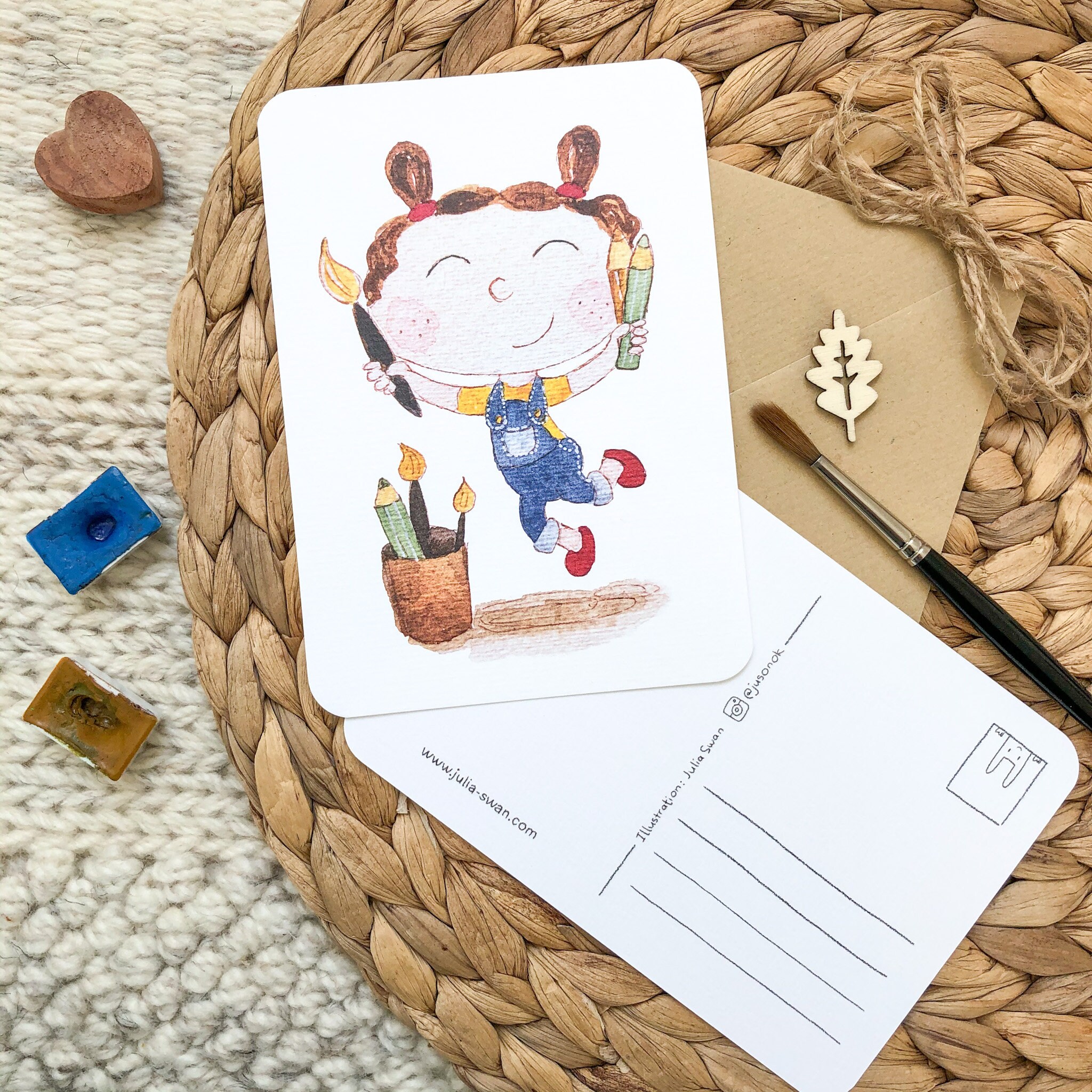 Hand-drawn postcard with a joyful girl jumping with a paint brush and colour pencils Hand-drawn postcard with a joyful girl jumping with a paint brush and colour pencils