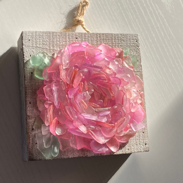 Sea Glass Peony Flower on whitewash wood wall panel frame with blush, coral, and mauve petals and sea foam green leaves