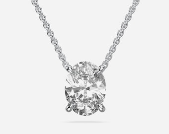 May include: A silver-toned necklace featuring a single oval-cut clear gemstone held in a four-prong setting. The pendant is suspended from a delicate cable chain. Below the jewelry, the text READY TO SHIP is printed in a simple gray font.