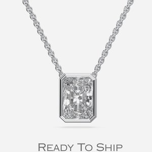 May include: A silver necklace featuring a rectangular, clear gemstone pendant. The pendant is set in a silver bezel and hangs from a delicate chain. The text "READY TO SHIP" is displayed below the necklace.