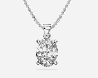 May include: A silver-toned necklace featuring a single oval-cut clear gemstone pendant held by four prongs on a delicate chain. The pendant is suspended from a simple bail. Below the jewelry, the text READY TO SHIP is printed in gray.