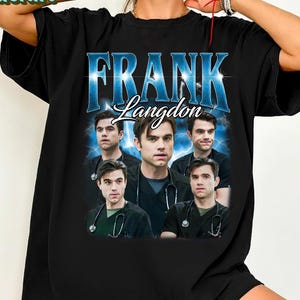 May include: Black t-shirt with the text "FRANK Langdon" in blue and white, and a collage of images of a person in medical scrubs. The top has a crew neck and short sleeves.