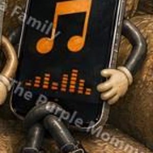May include: A smartphone character with black arms and legs wearing black and white sneakers. The screen displays a large orange musical note icon above an orange sound wave graphic. The device has a metallic frame and is posed in a seated position.