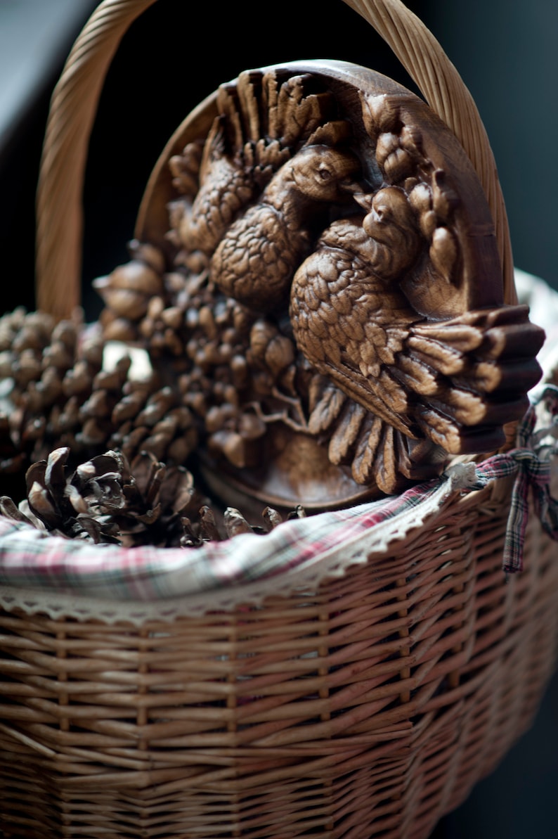 Round carved panel depicting doves