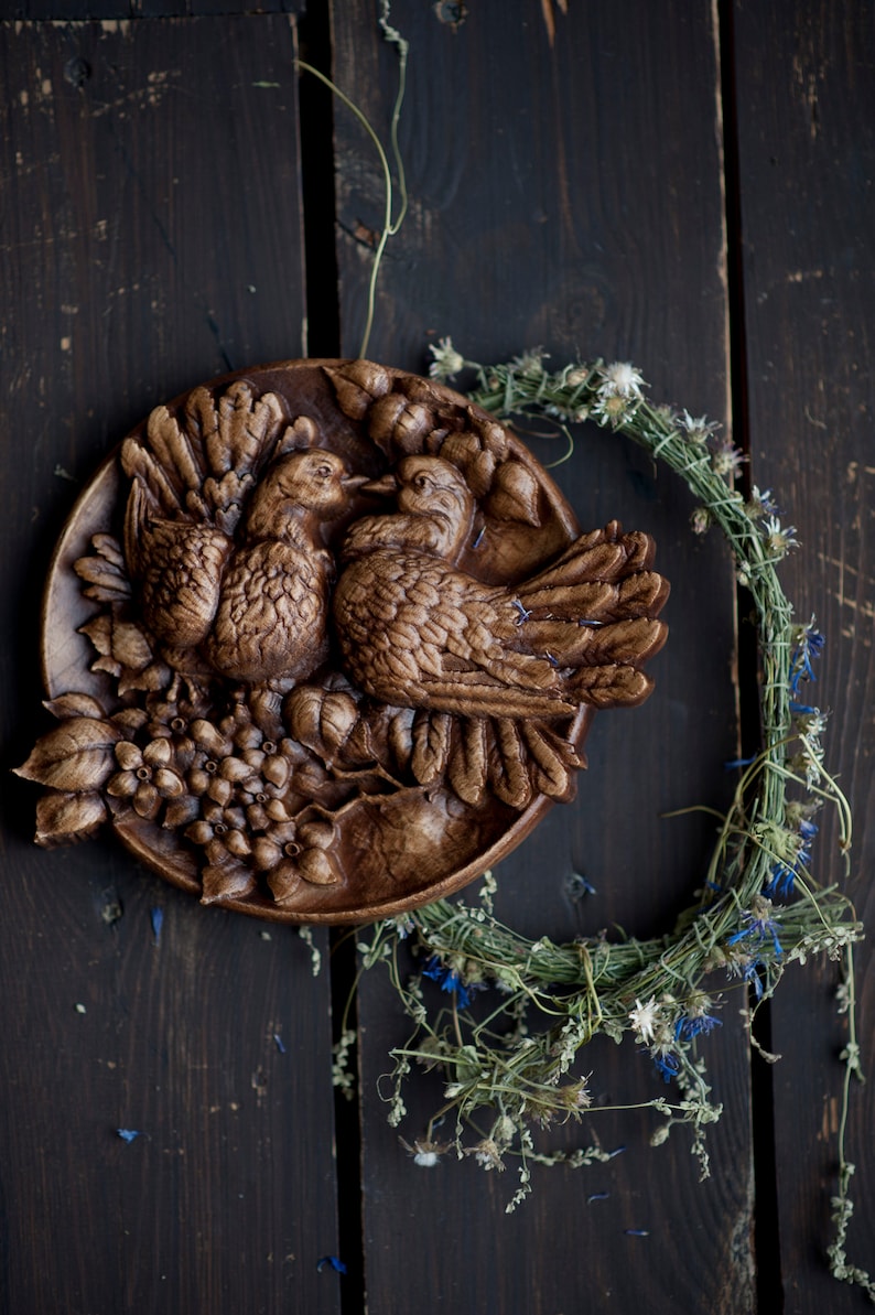 Round carved panel depicting doves