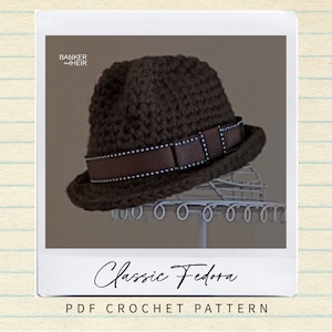 May include: A brown crochet fedora hat with a brown ribbon and white polka dots. The hat is on a white stand. The text "Classic Fedora PDF CROCHET PATTERN" is below the image.