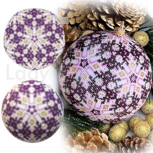 May include: Purple and white beaded snowflake bauble with a gold top. The bauble is made with peyote stitch and has a 3D ball shape. The bauble is surrounded by pine cones and other decorative elements.