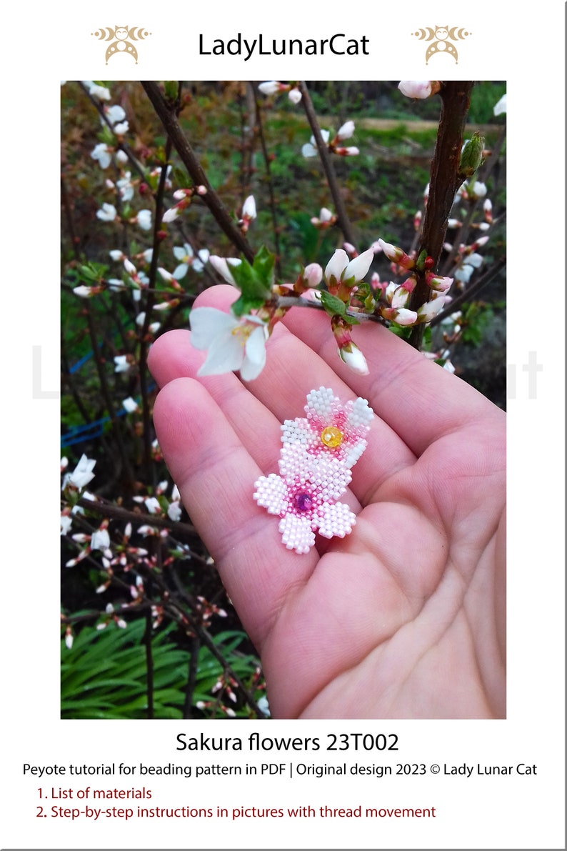 May include: A close-up of a hand holding a beaded pink and white flower. The flower is a beaded replica of a cherry blossom. The text "Sakura flowers 23T002" is below the image.